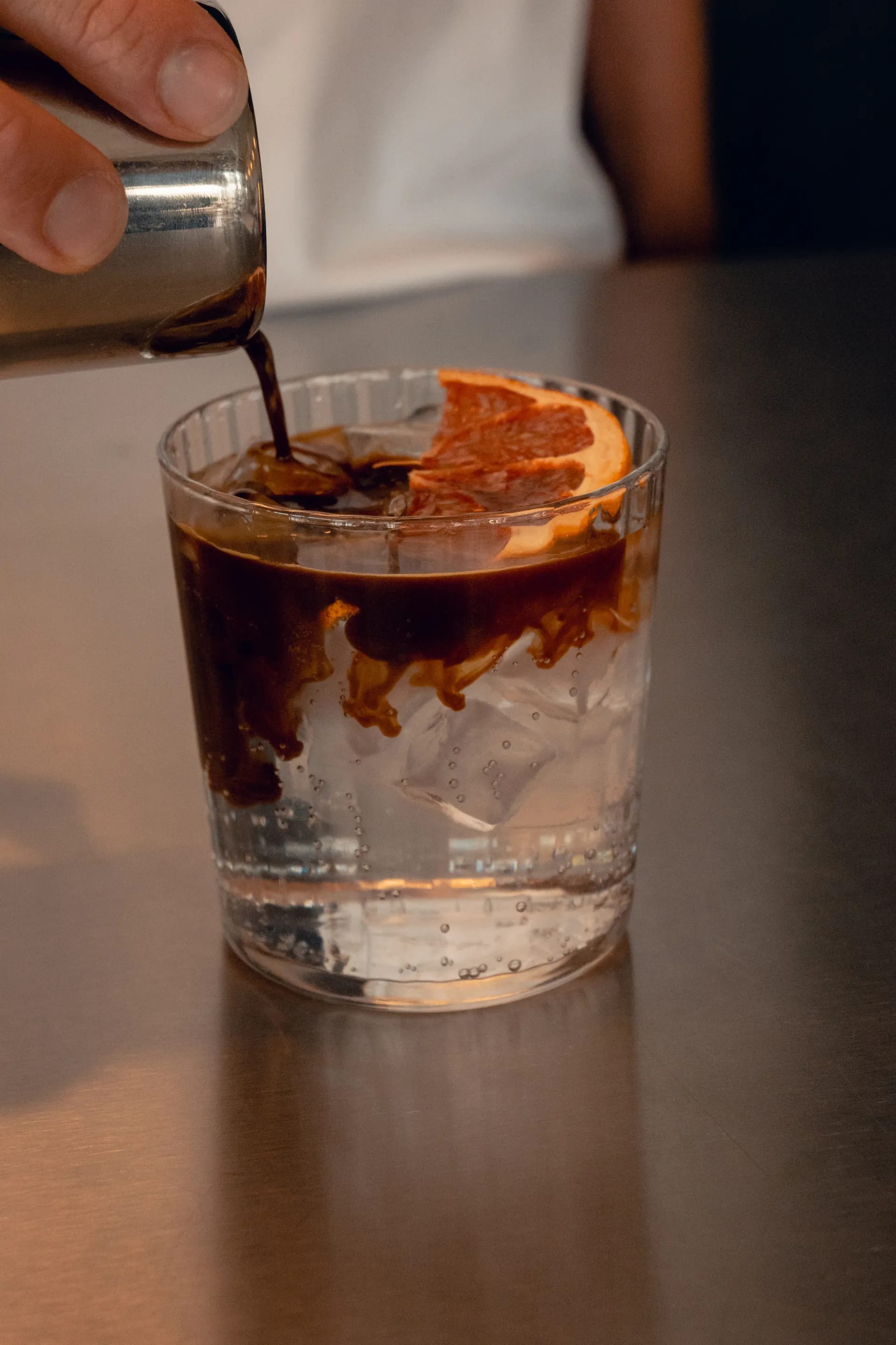 Espresso poured over ice and orange